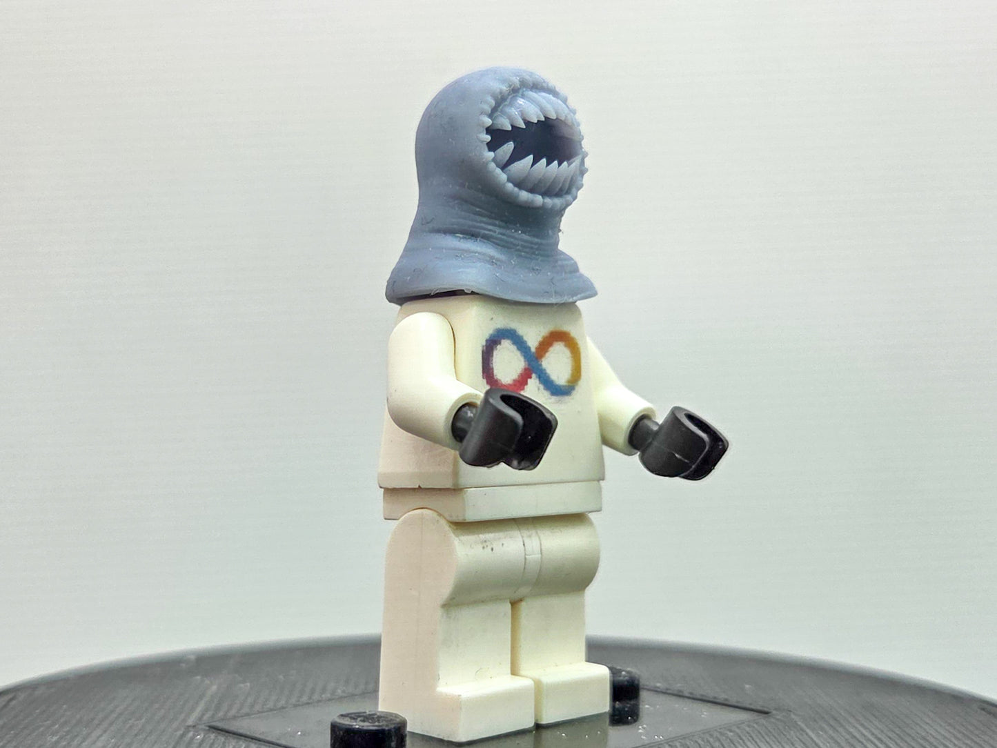 Custom 3D printed alien with a lot of teeth wearing yellow ring