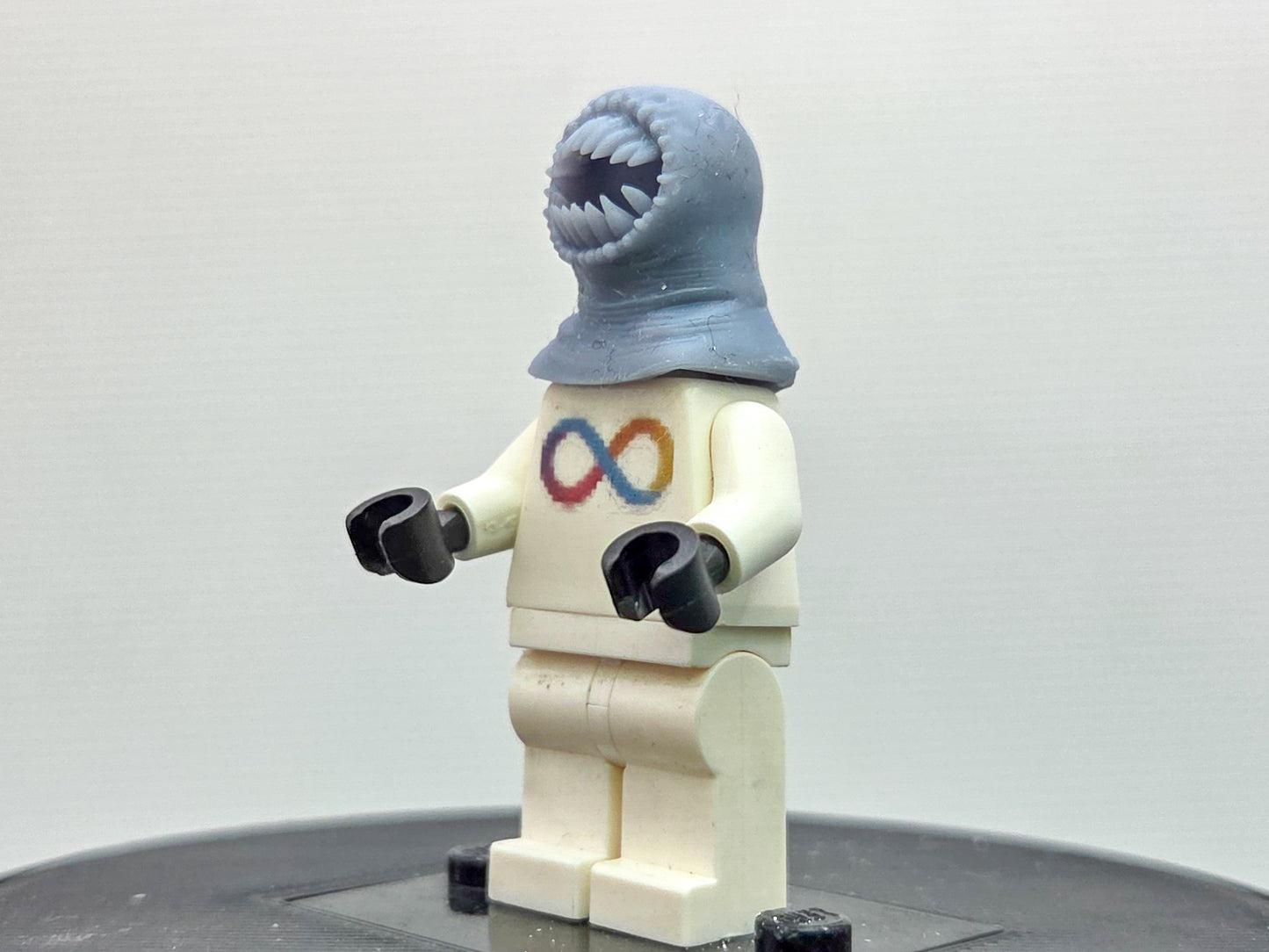 Custom 3D printed alien with a lot of teeth wearing yellow ring