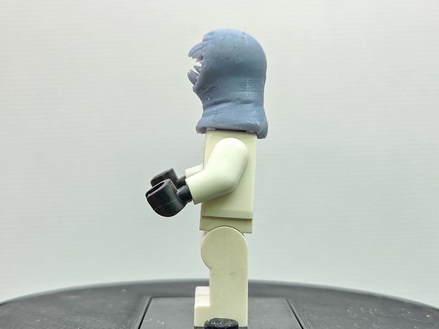 Custom 3D printed alien with a lot of teeth wearing yellow ring